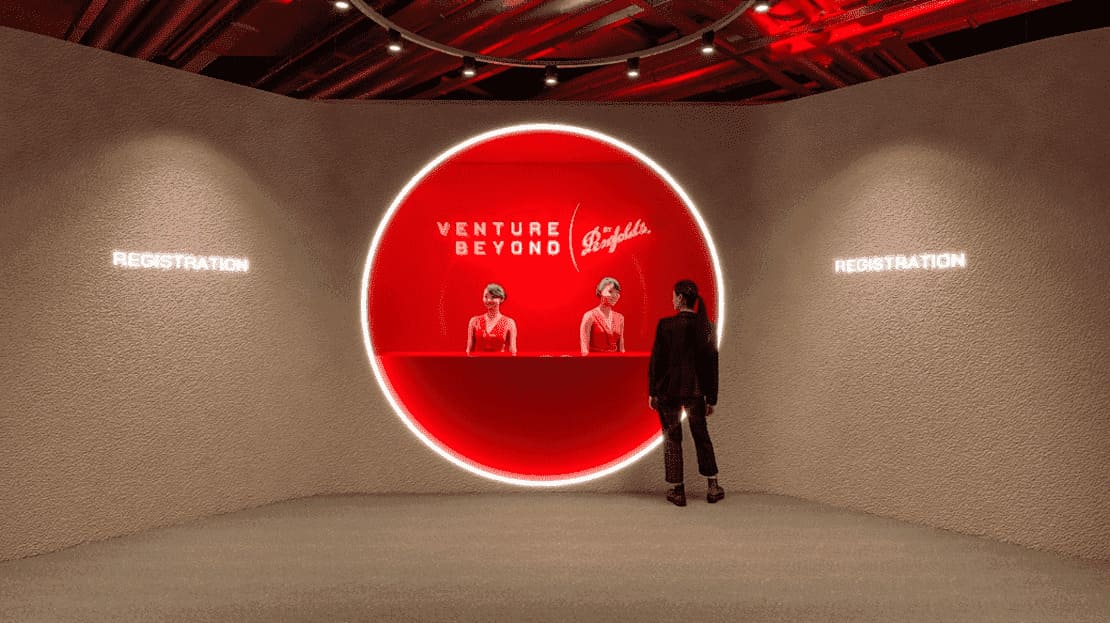 The futuristic registration desk at Venture Beyond by Penfolds - two ladies stand behind the desk while a visitor speaks with one of them
